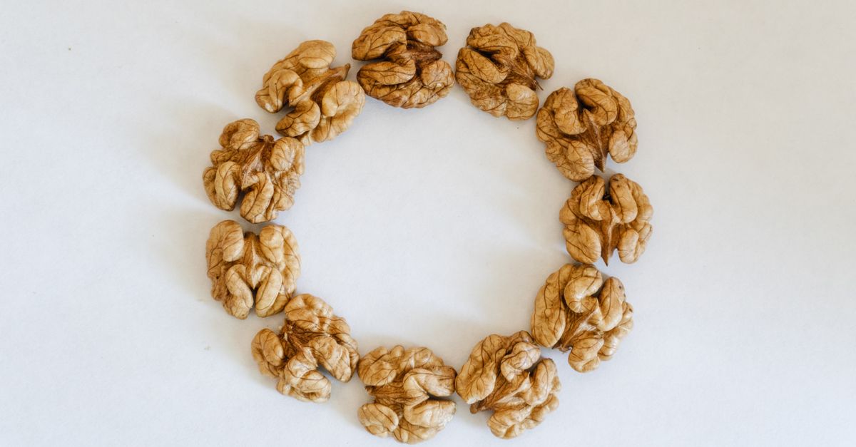 Top view of walnuts arranged in a circle on a white background, showcasing texture. - Evidence evidence guide for walnut cognition randomized trial