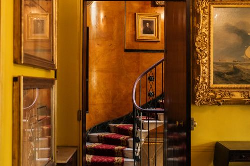 Free Opulent interior featuring a spiral staircase, ornate paintings, and luxurious decor in a London setting. Stock Photo