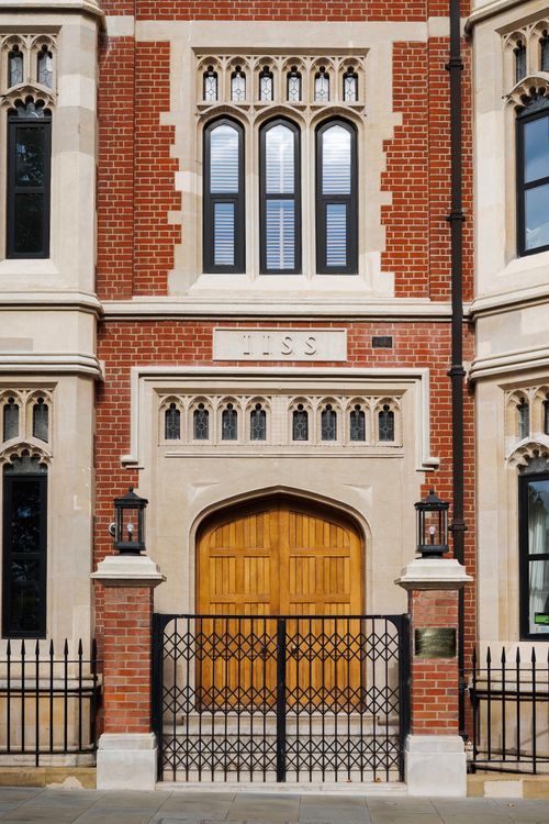 Free A detailed view of a historic brick building facade with Gothic elements in London, UK. Stock Photo