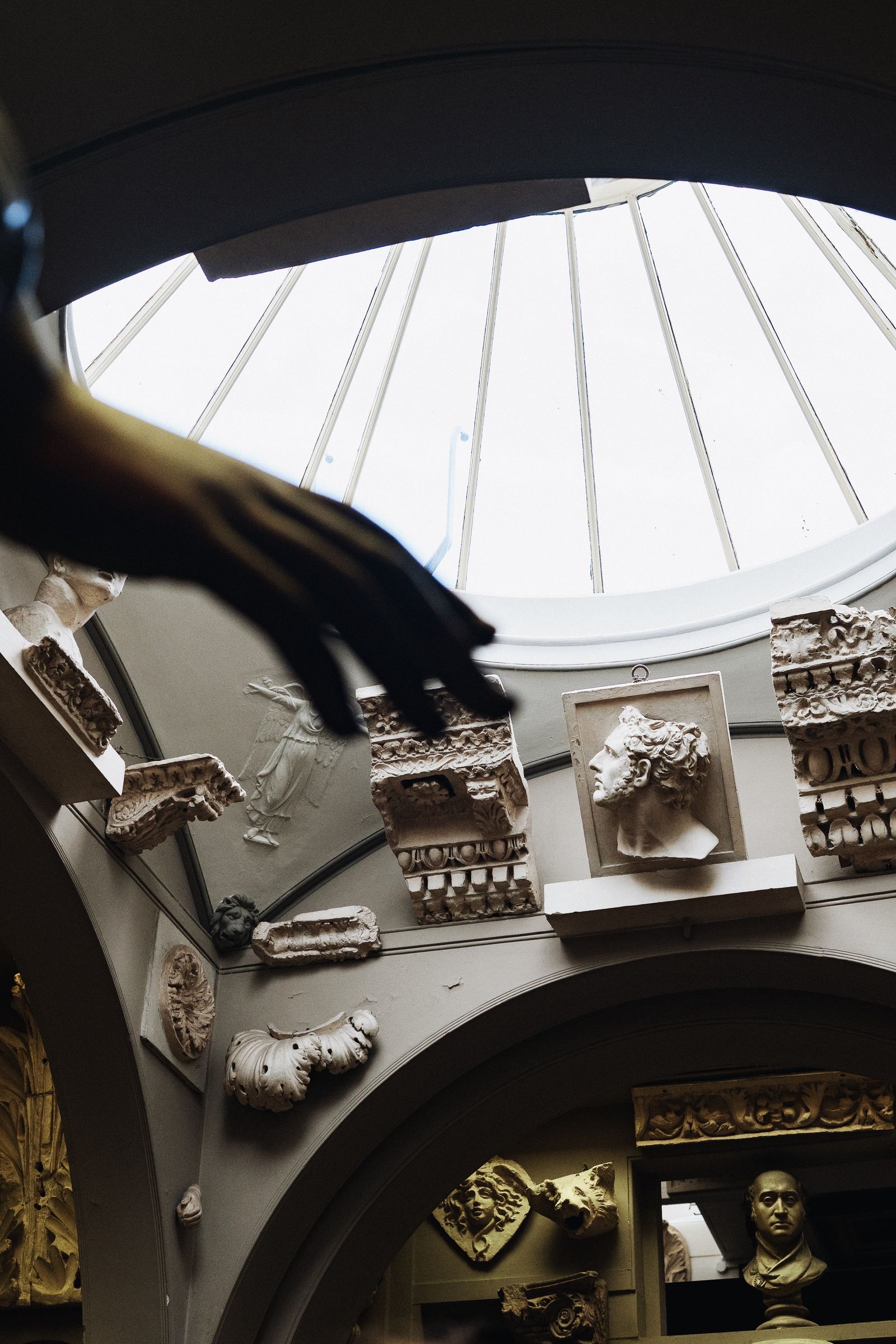 Historic plaster cast sculptures displayed in a British Museum gallery under a skylight dome