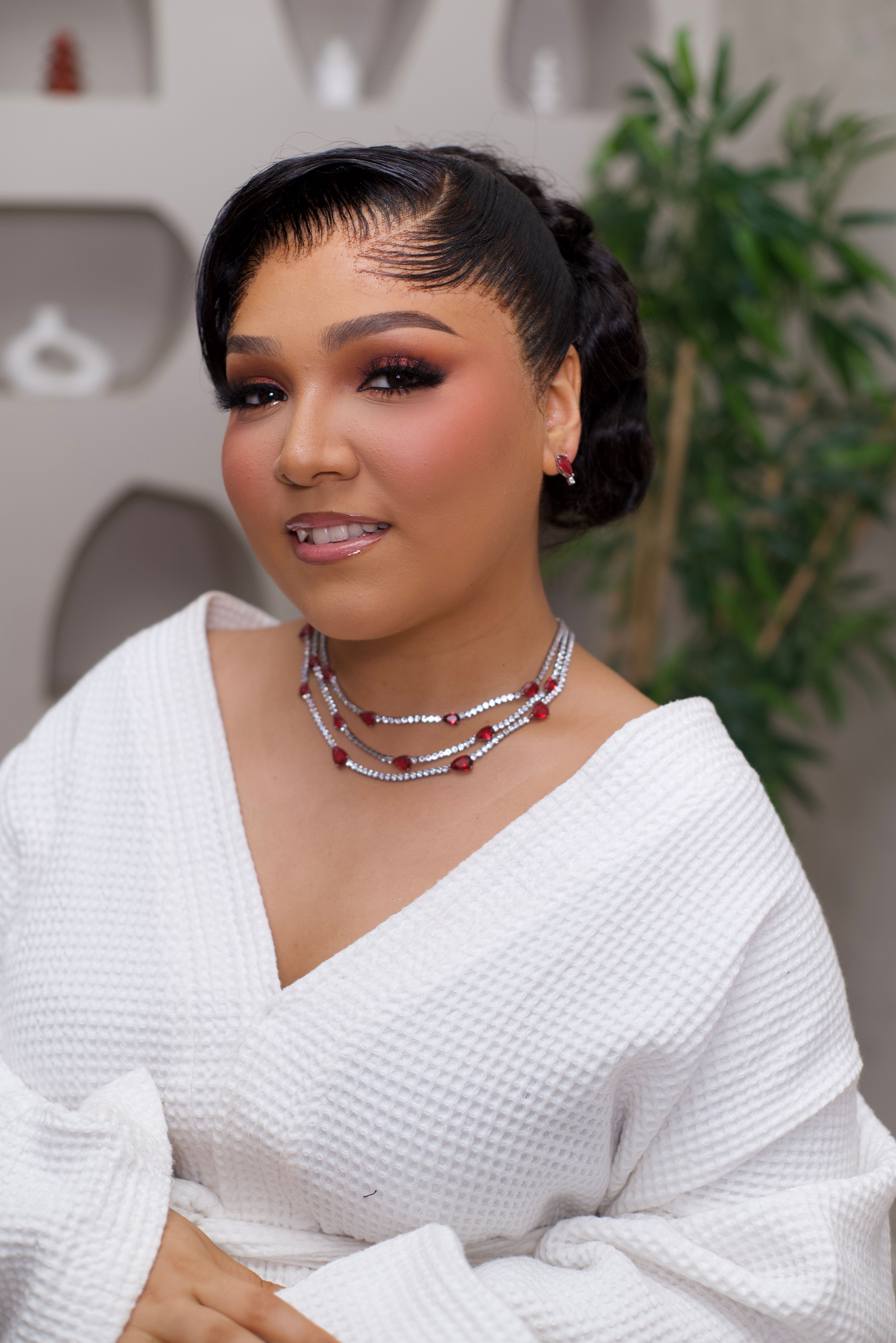 A stylish portrait of a confident woman showcasing elegance and modern fashion indoors.