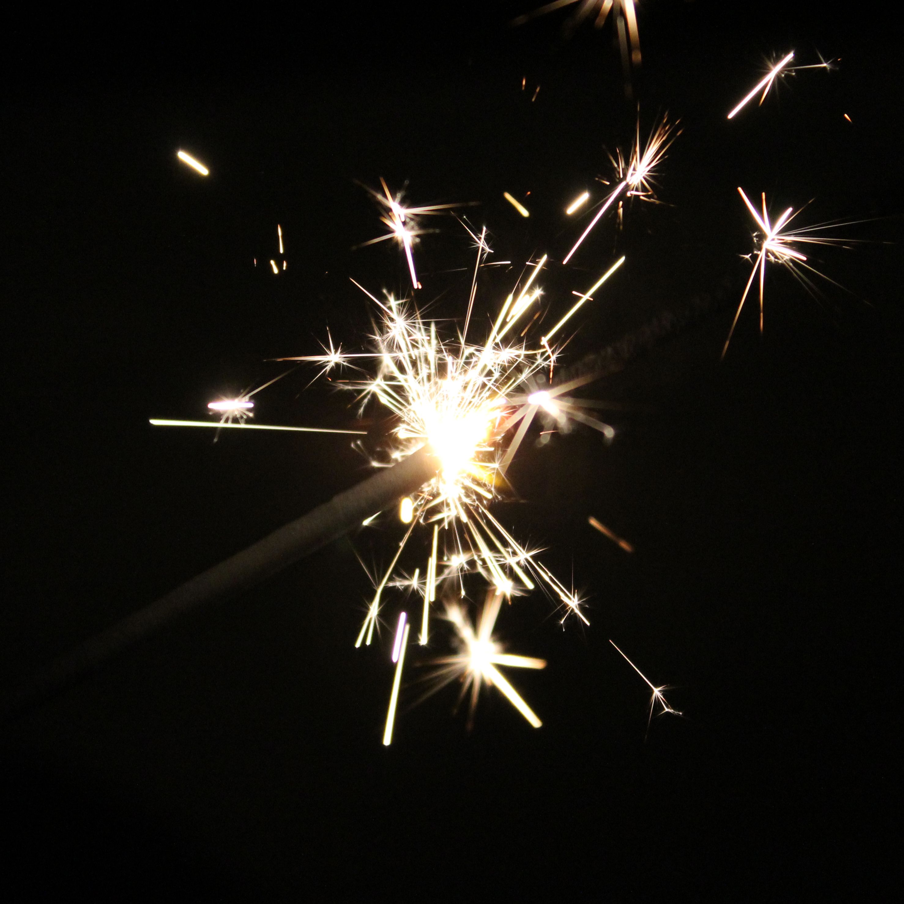 Vibrant sparkler illuminating the darkness, ideal for festive or celebratory themes.