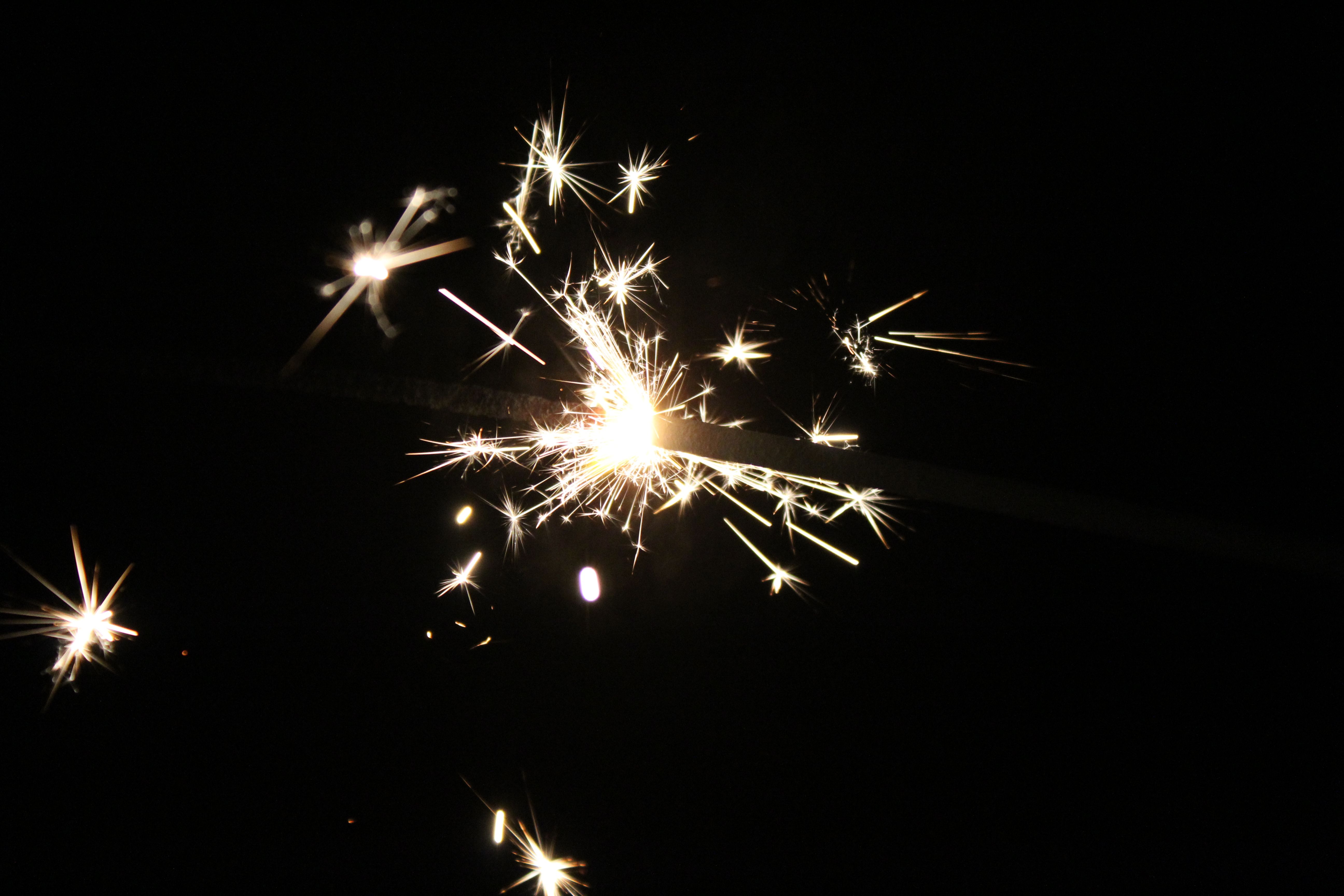A captivating sparkler illuminates the night with vibrant sparks, capturing a moment of celebration.