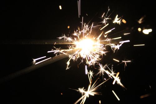 Free Close-up of a bright sparkler igniting against a dark background, perfect for festive occasions. Stock Photo