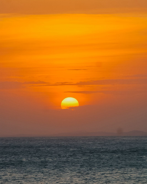 Free Breathtaking sunset over the ocean in Salvador, Bahia, with vibrant orange hues. Stock Photo