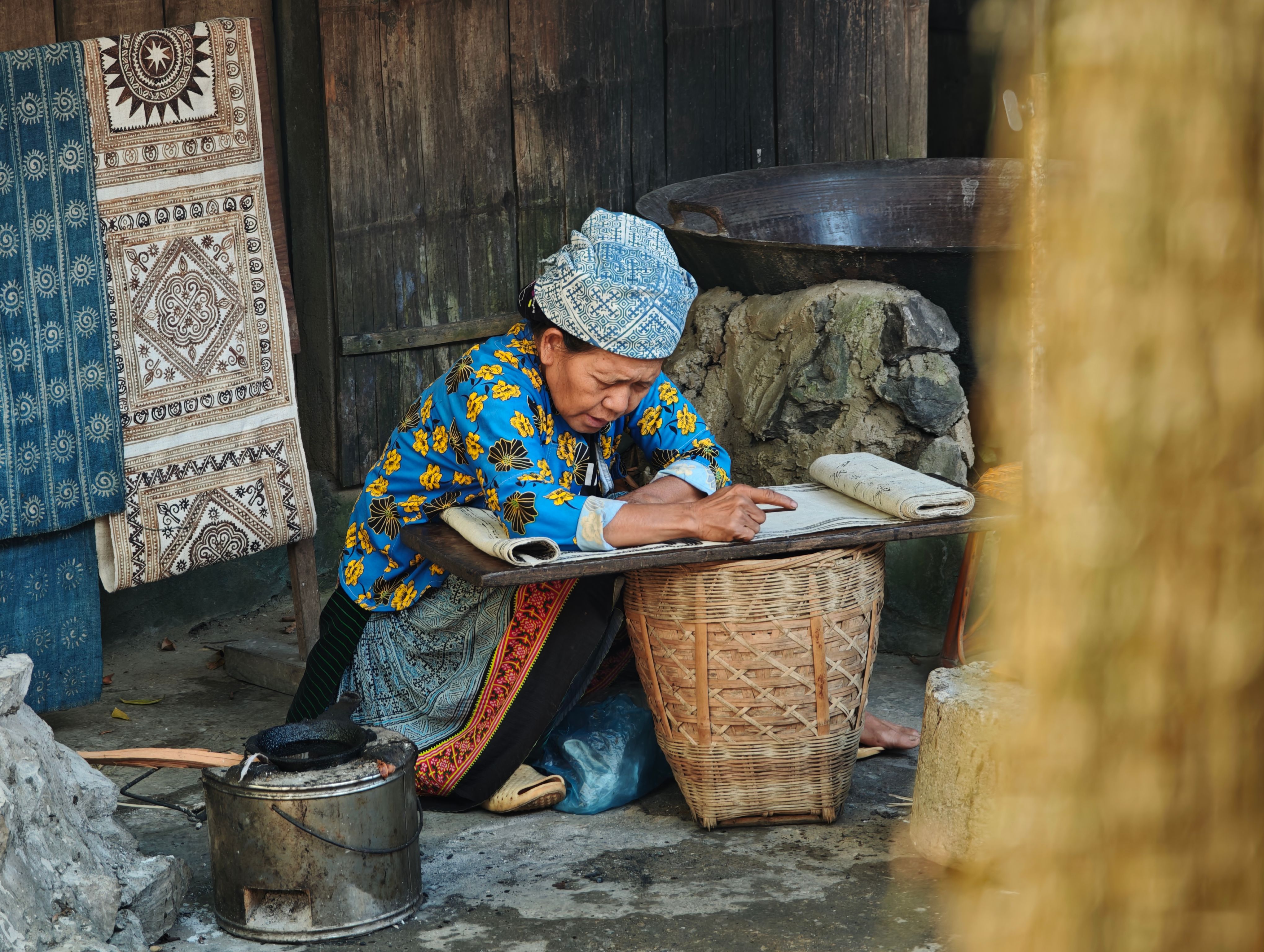 Woman teaching child batik dyeing
