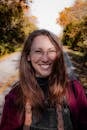 Smiling Woman in Autumn on Country Road