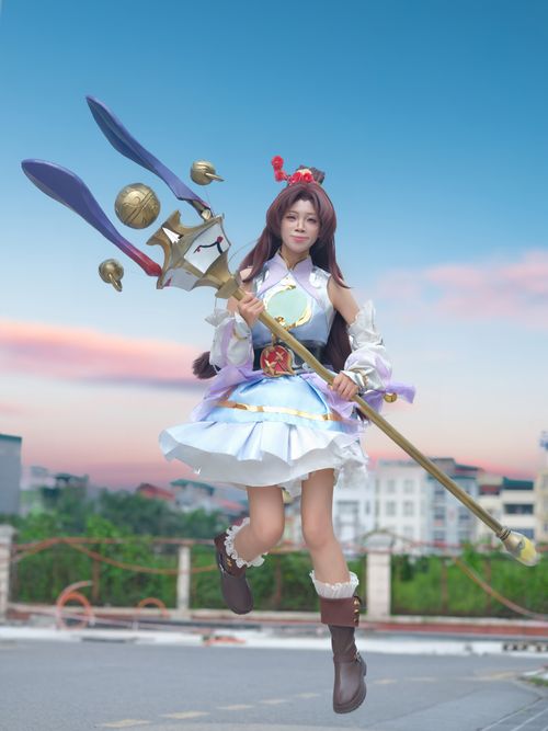 Free Cosplayer in intricate costume holding a magical staff in an outdoor urban setting. Stock Photo