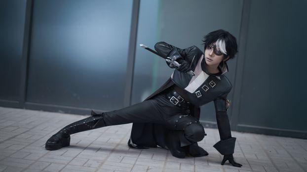 A captivating cosplay portrait featuring a character in dramatic pose with dark attire and striking makeup.