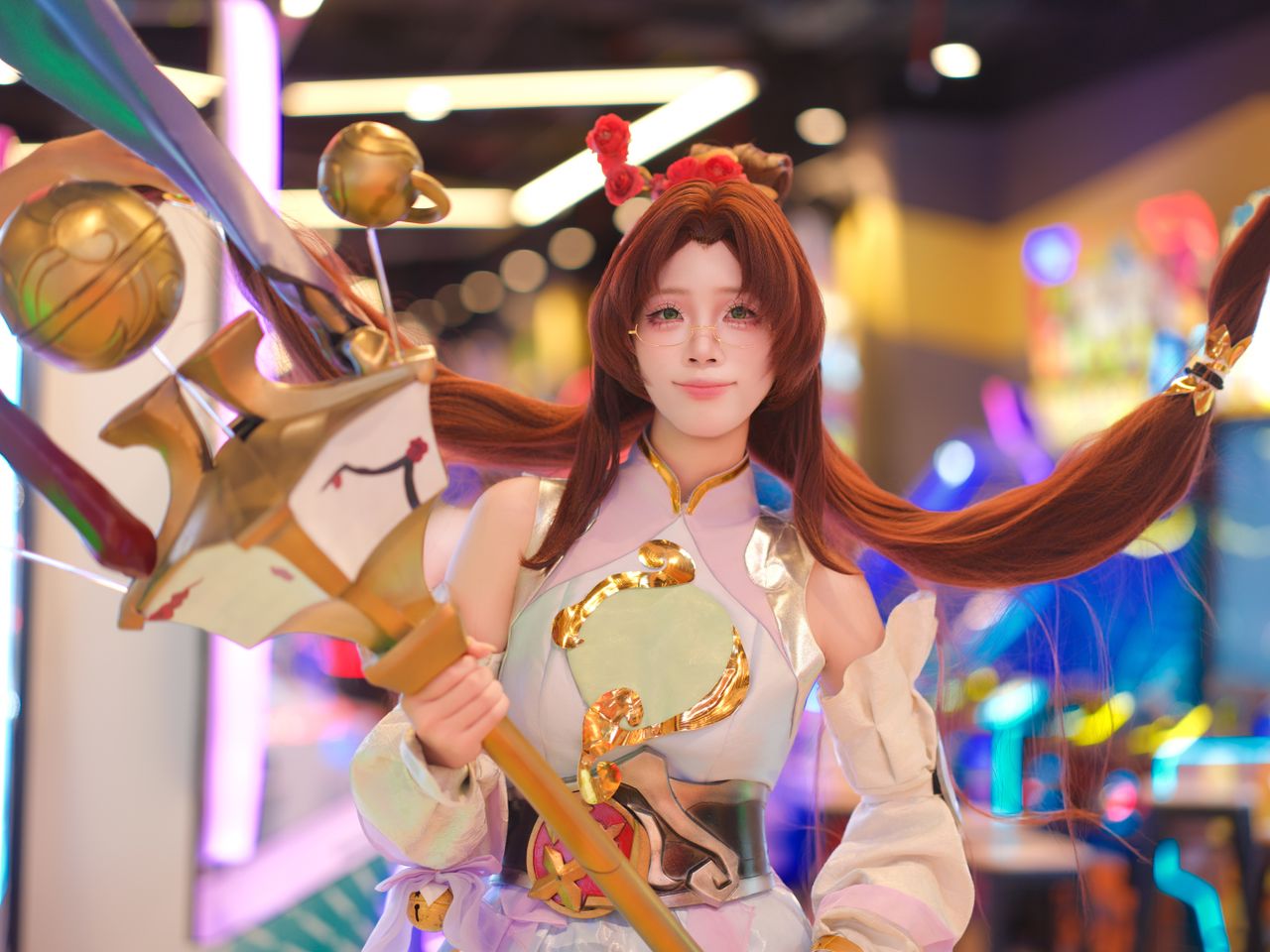 cosplayer in elaborate costume poses in vibrant colorful arcade enviro