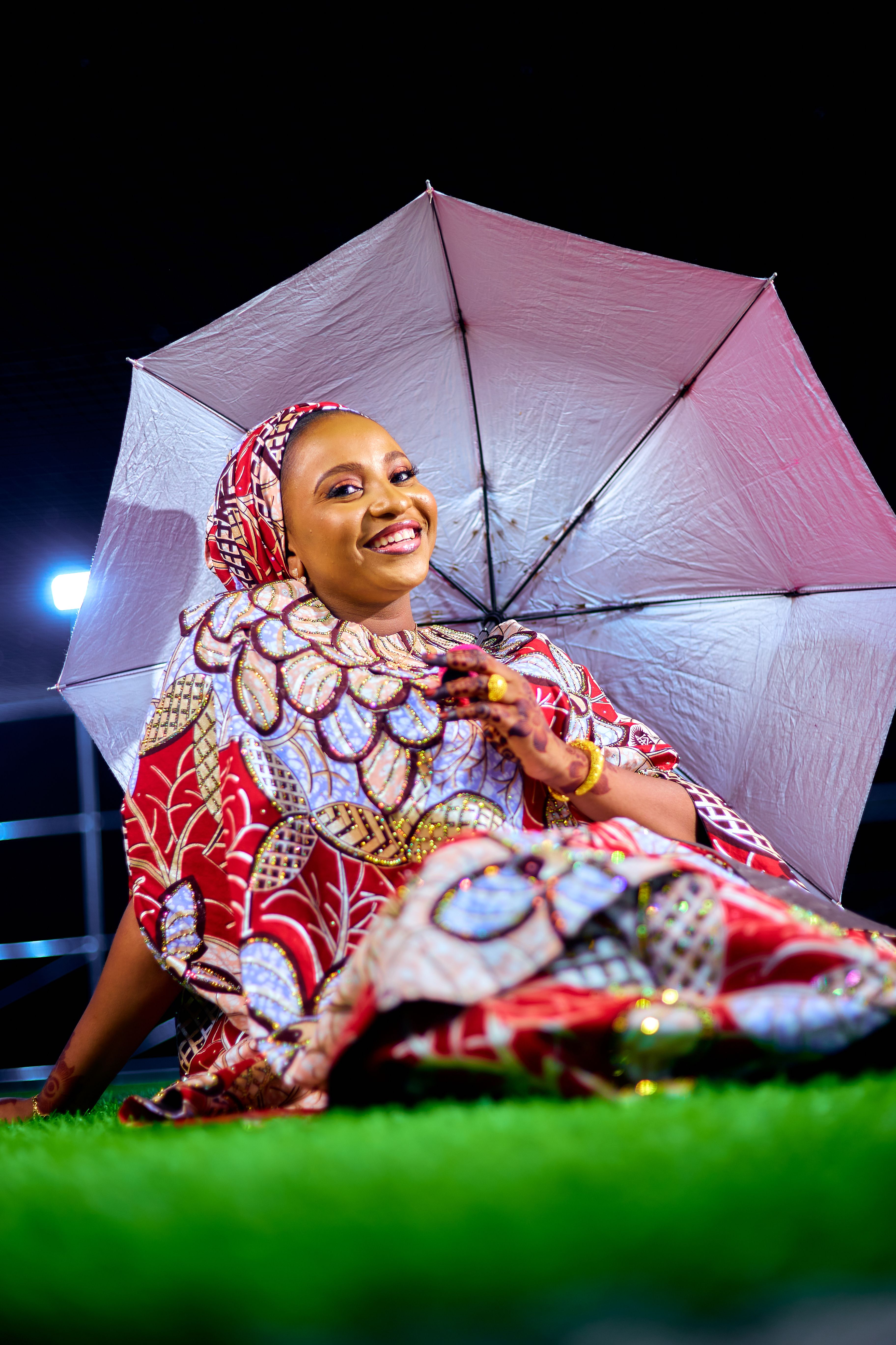 Smiling Woman in Colorful Traditional Attire with Umbrella · Free Stock ...