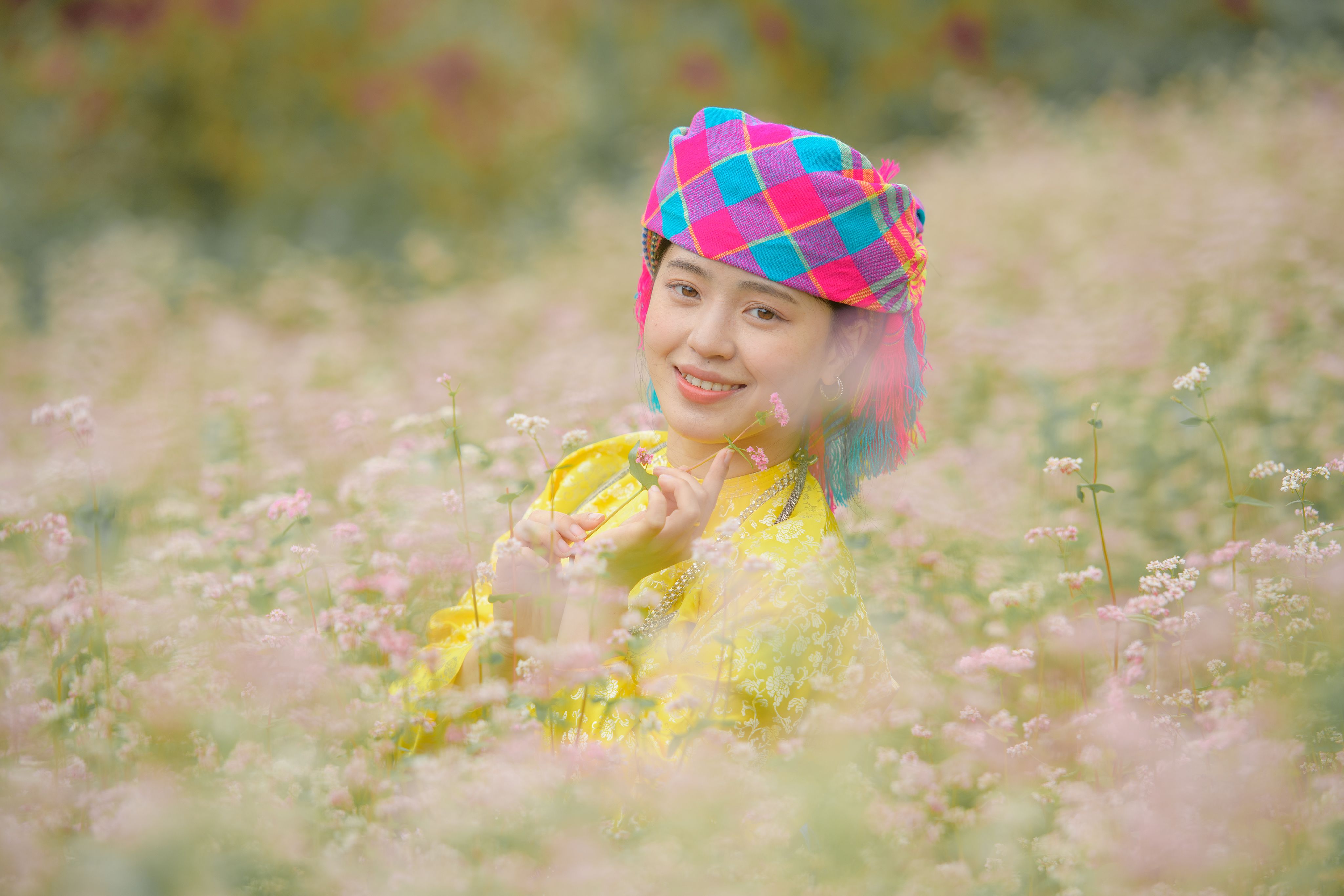 Young Woman in Vibrant Traditional Dress in Flower Field · Free Stock Photo