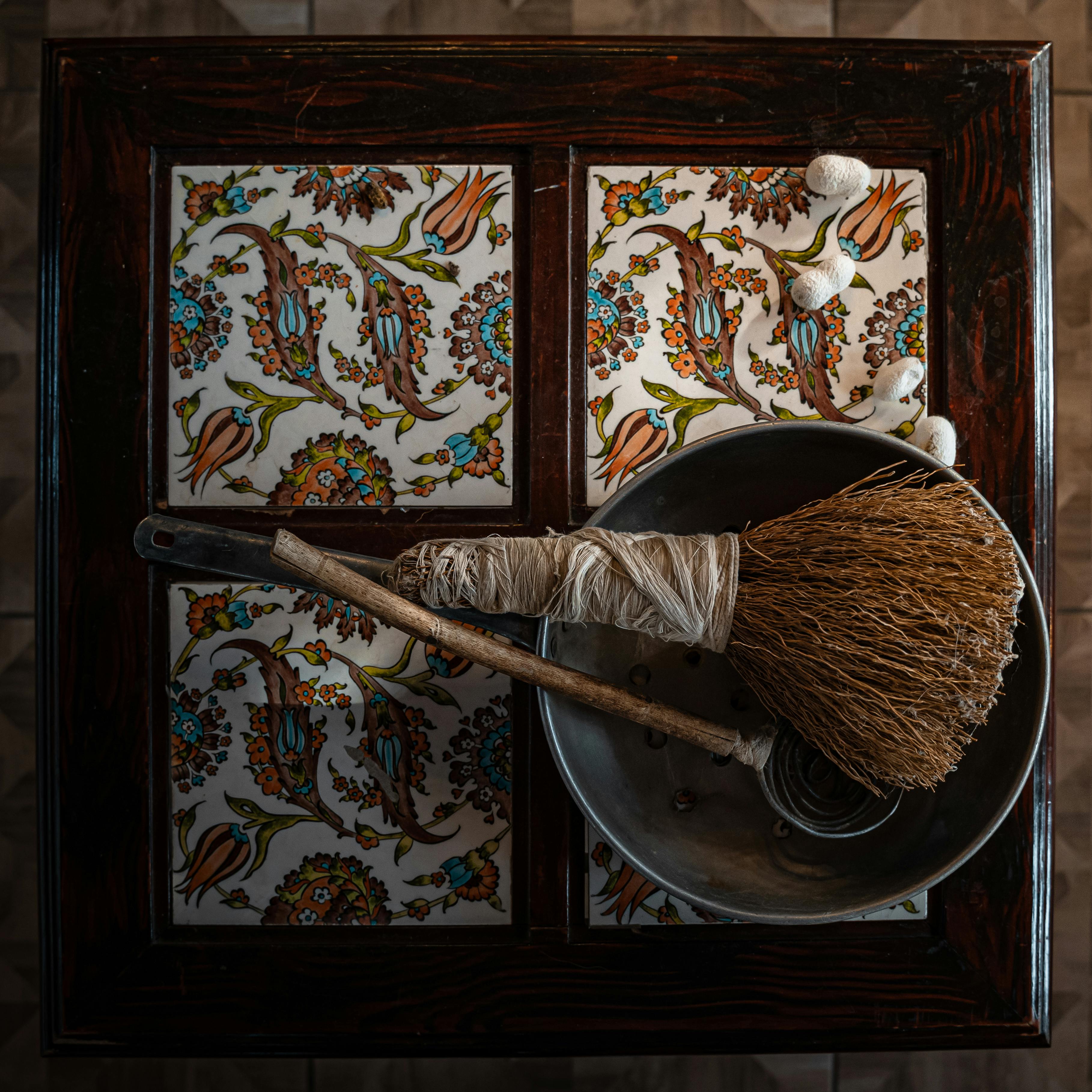 Handcrafted broom and ceramic tiles showcasing Turkish artistry.