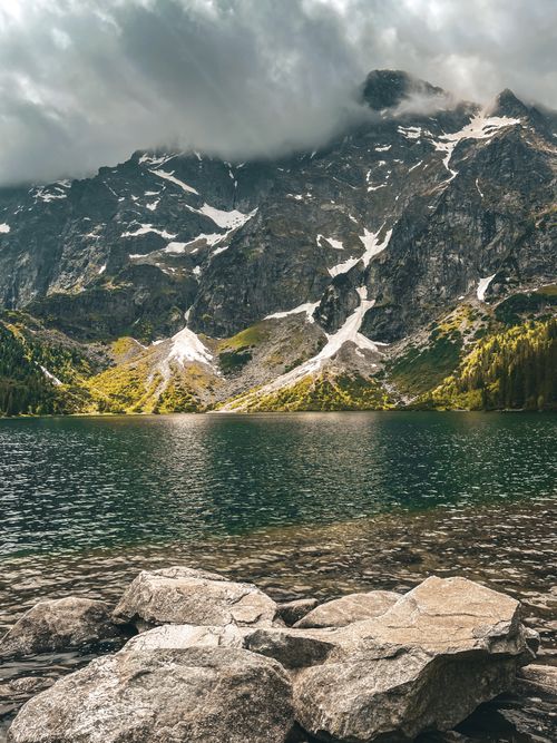 Free Serene landscape of Morskie Oko lake and snow-capped Tatra Mountains in Poland. Stock Photo