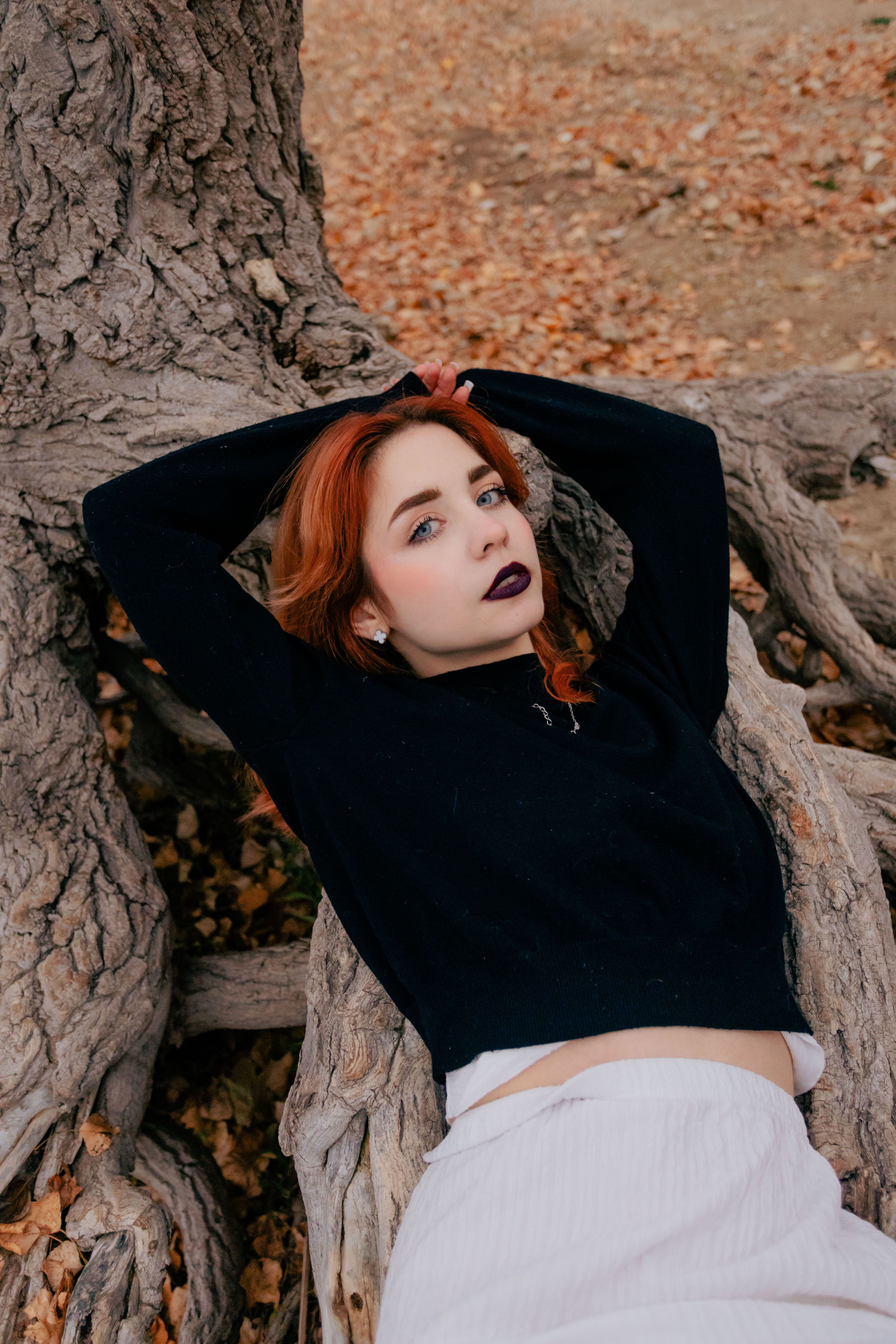 Young Woman Relaxing Among Tree Roots · Free Stock Photo