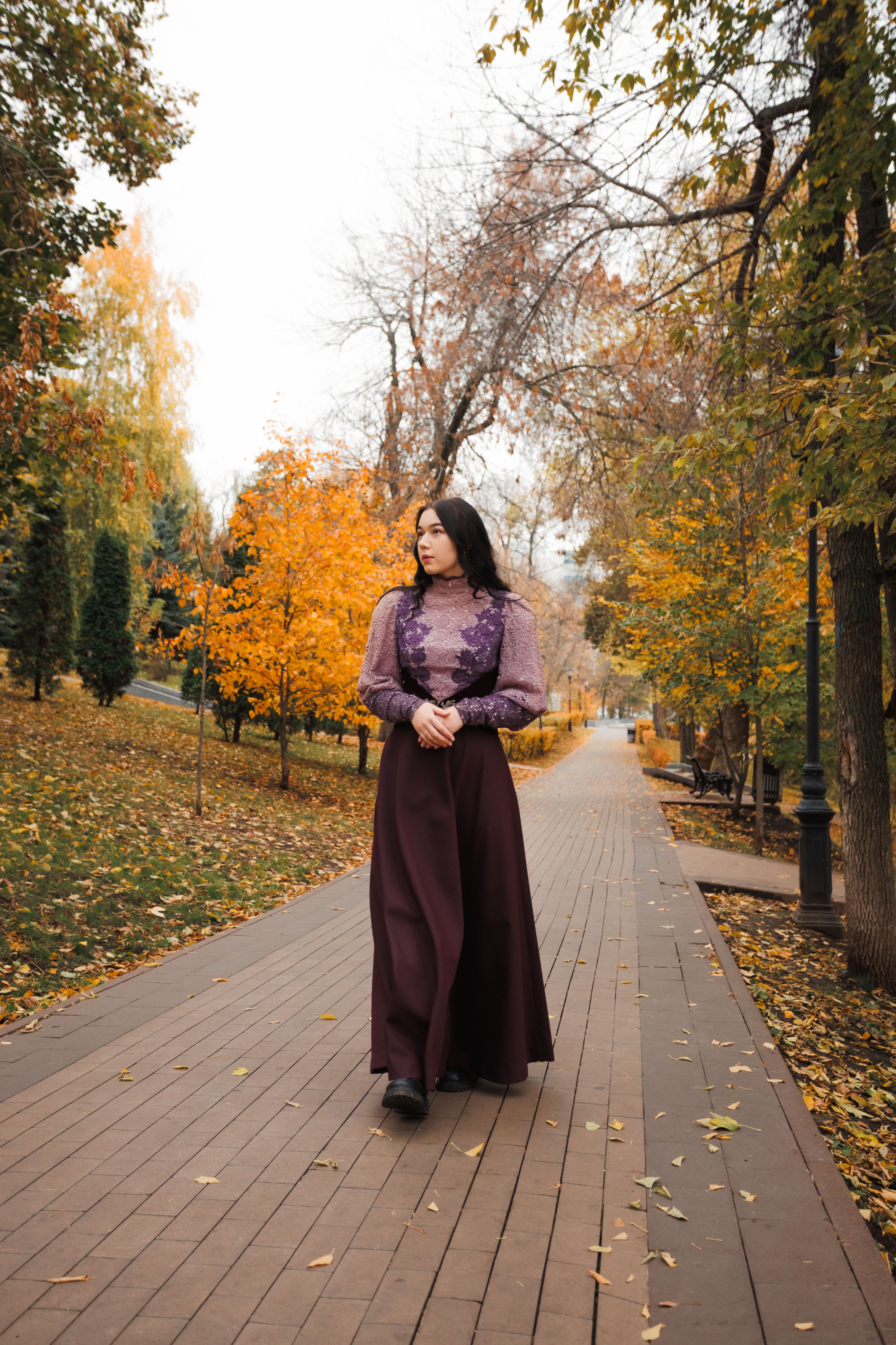 Woman Strolling in Autumn Park Pathway · Free Stock Photo