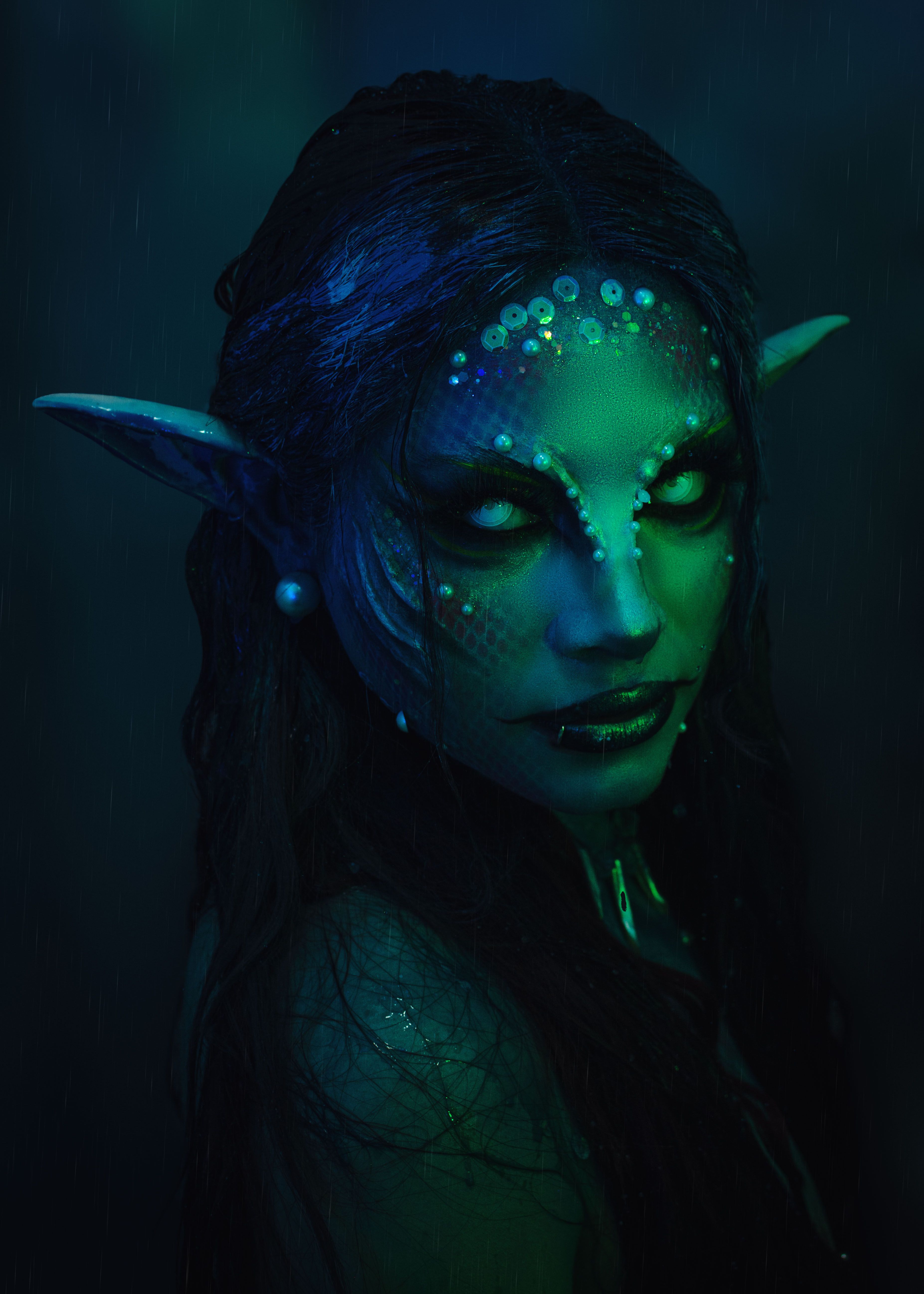 Dark and moody portrait of a fantasy creature with elf ears and mystical makeup in Cochabamba.