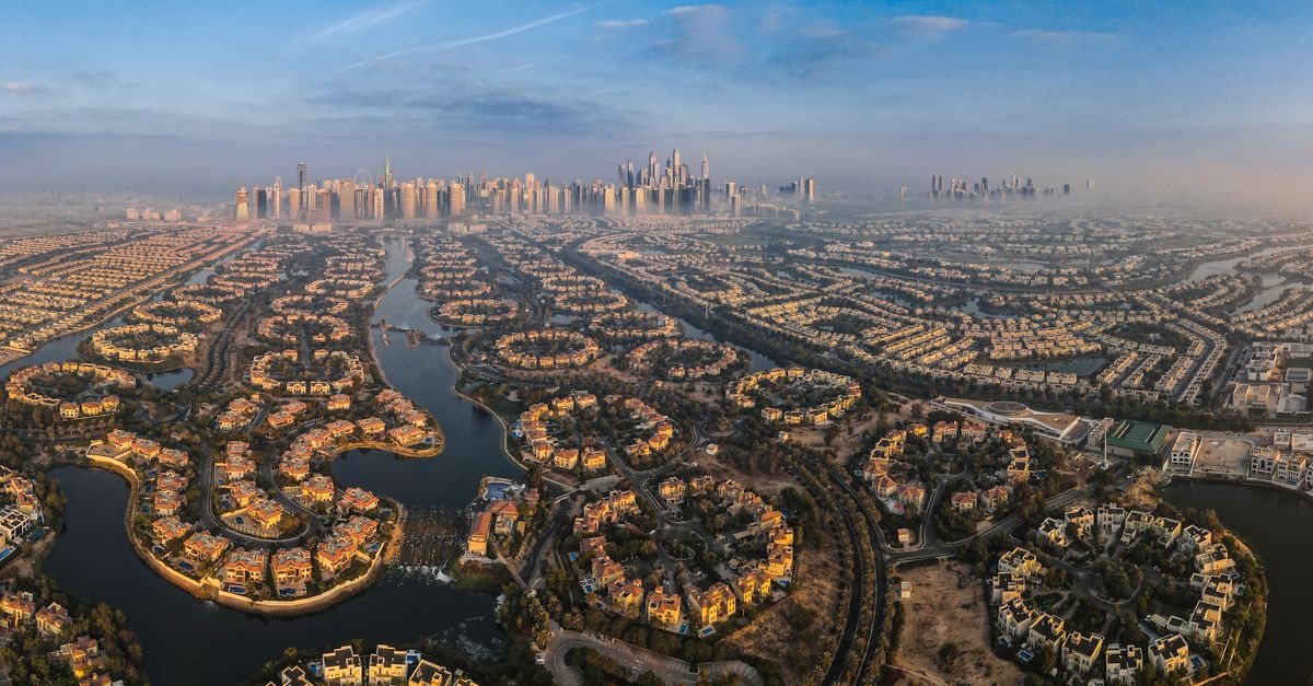A breathtaking aerial shot of Dubai's distinctive city layout with water channels and modern skyline.