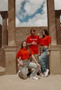 Fashionable Trio in Red Tops Posing Outdoors