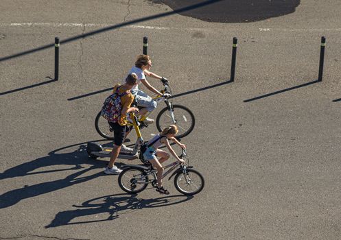 A family biking together outdoors on a sunny day, capturing freedom and connection.