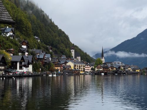 Free A picturesque view of Hallstatt village with alpine backdrop and lake reflections. Stock Photo