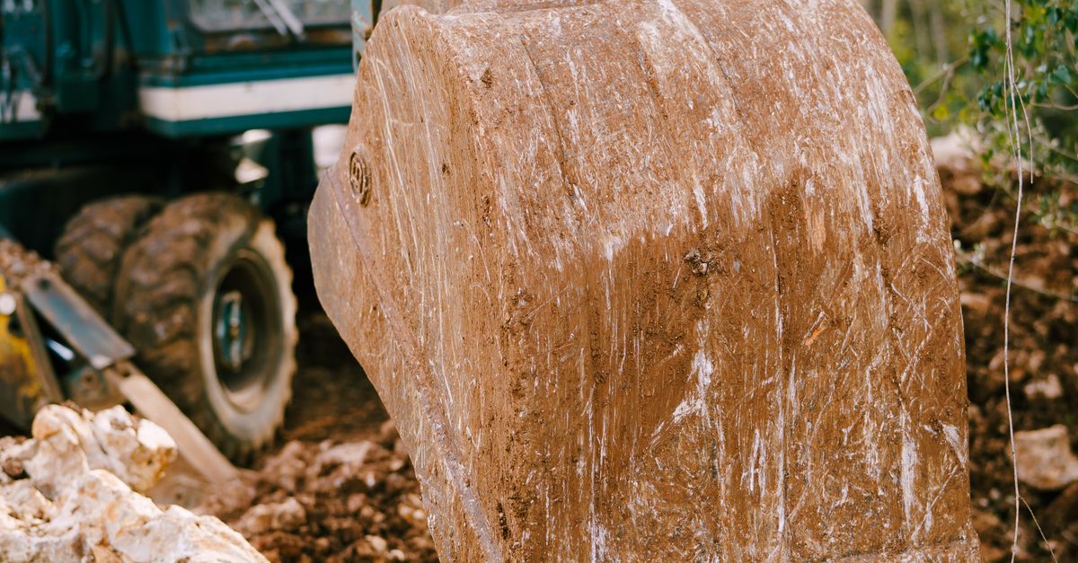 Digging By Compress Industrial Excavator Digging at Construction Site · Free Stock Photo