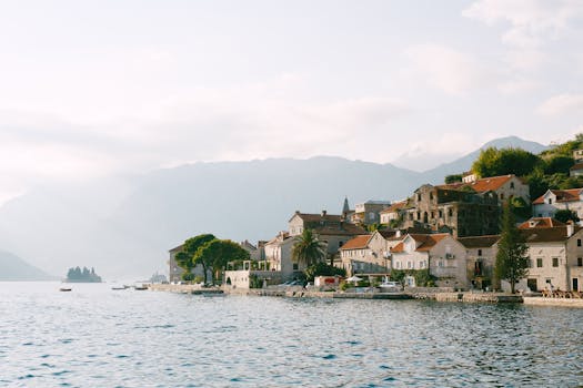 Charming coastal town along Kotor Bay, Montenegro, showcasing stone buildings and serene waterfront.