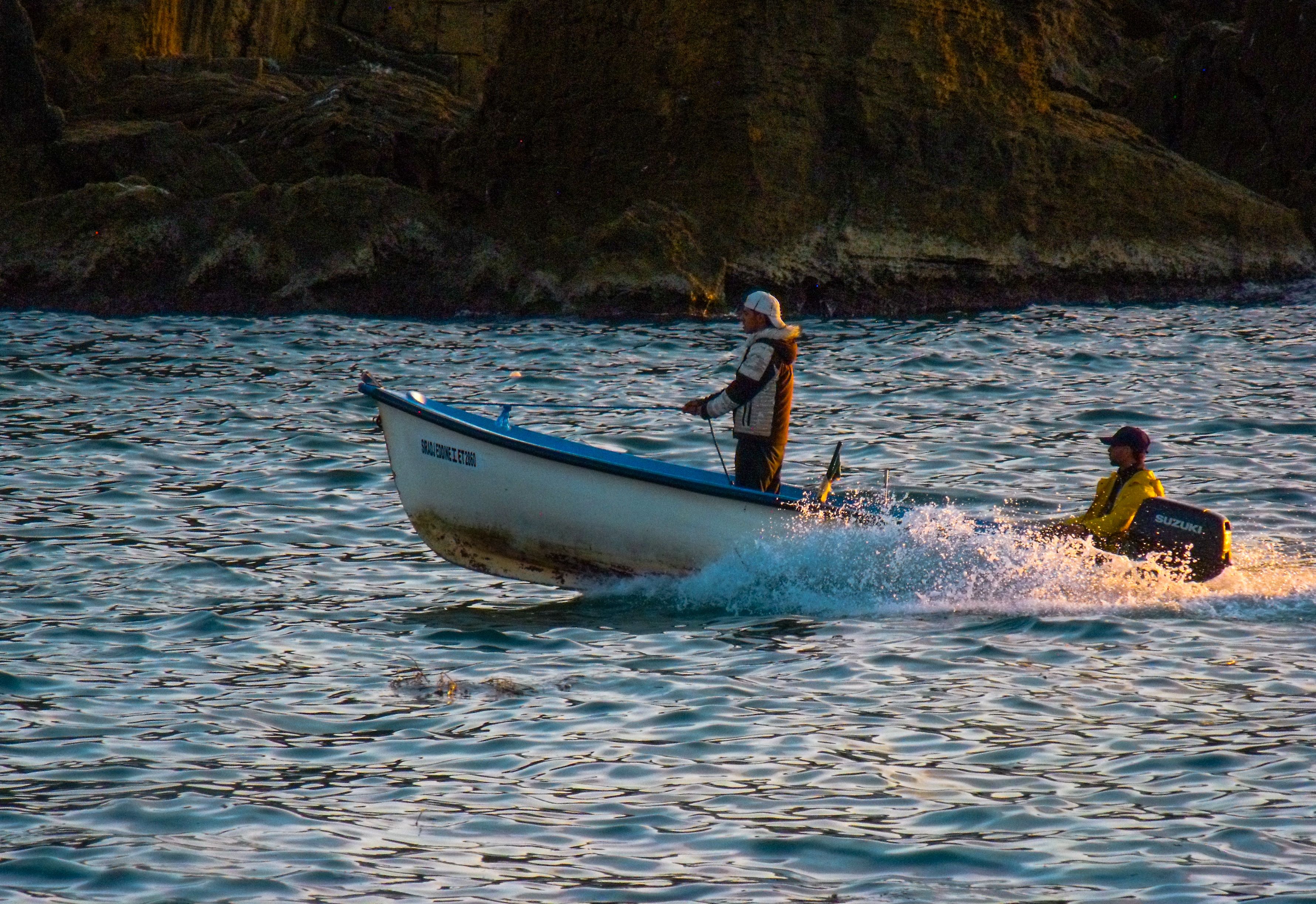 Men Boating on Serene Waters at Sunset · Free Stock Photo