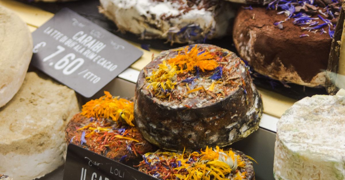Photo Editor Monitor Assorted Italian Cheeses in Florentine Market Display · Free Stock Photo