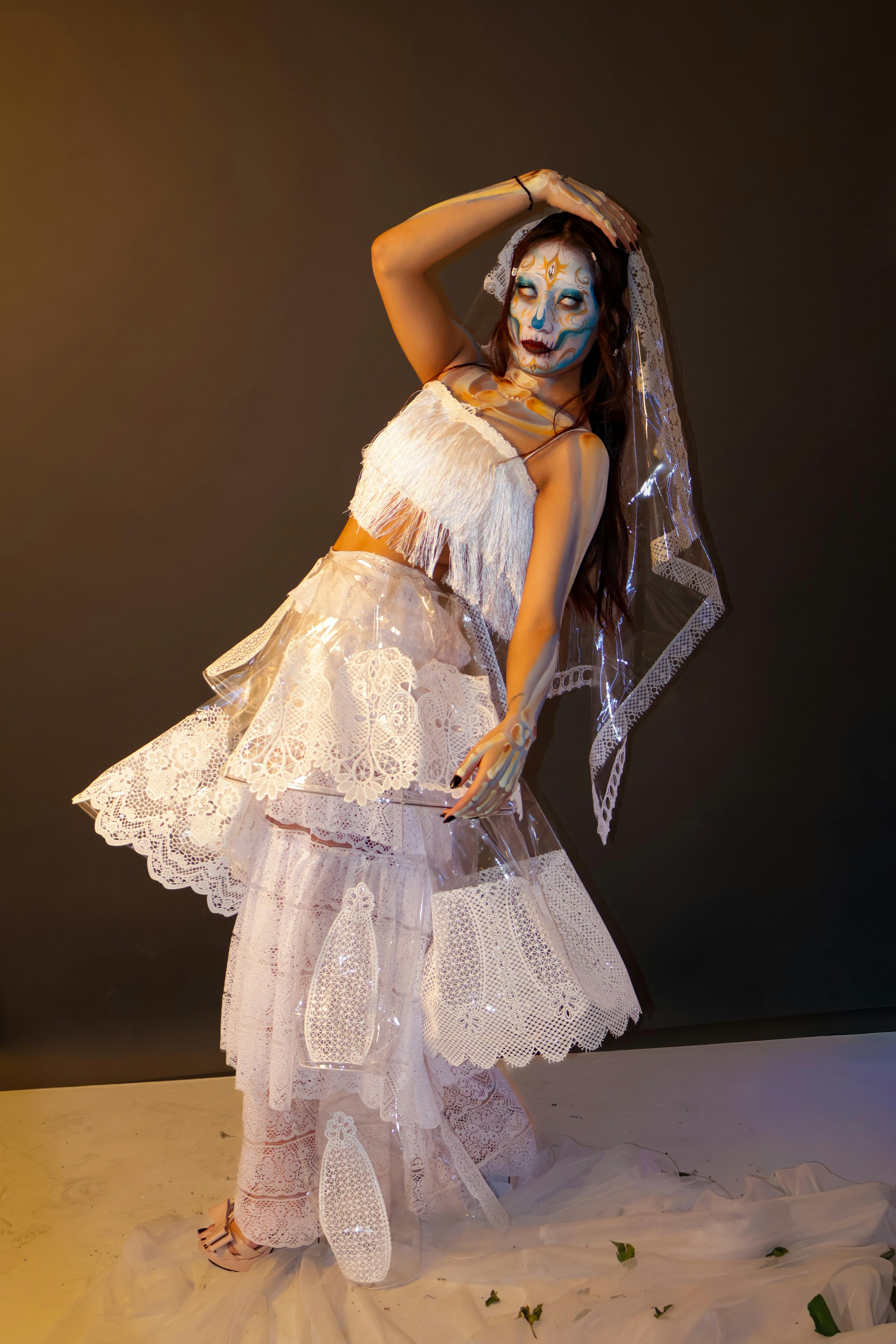 Free Artistic portrait of a woman in a unique lace costume and dramatic makeup, showcasing creativity. Stock Photo