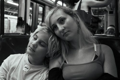 Free A serene black and white photo captures a tender moment between mother and child on a Barcelona subway. Stock Photo