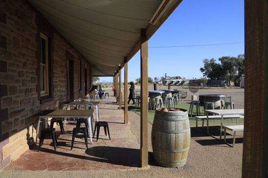 Rustic outback pub with wooden tables under a shaded veranda in South Australia.