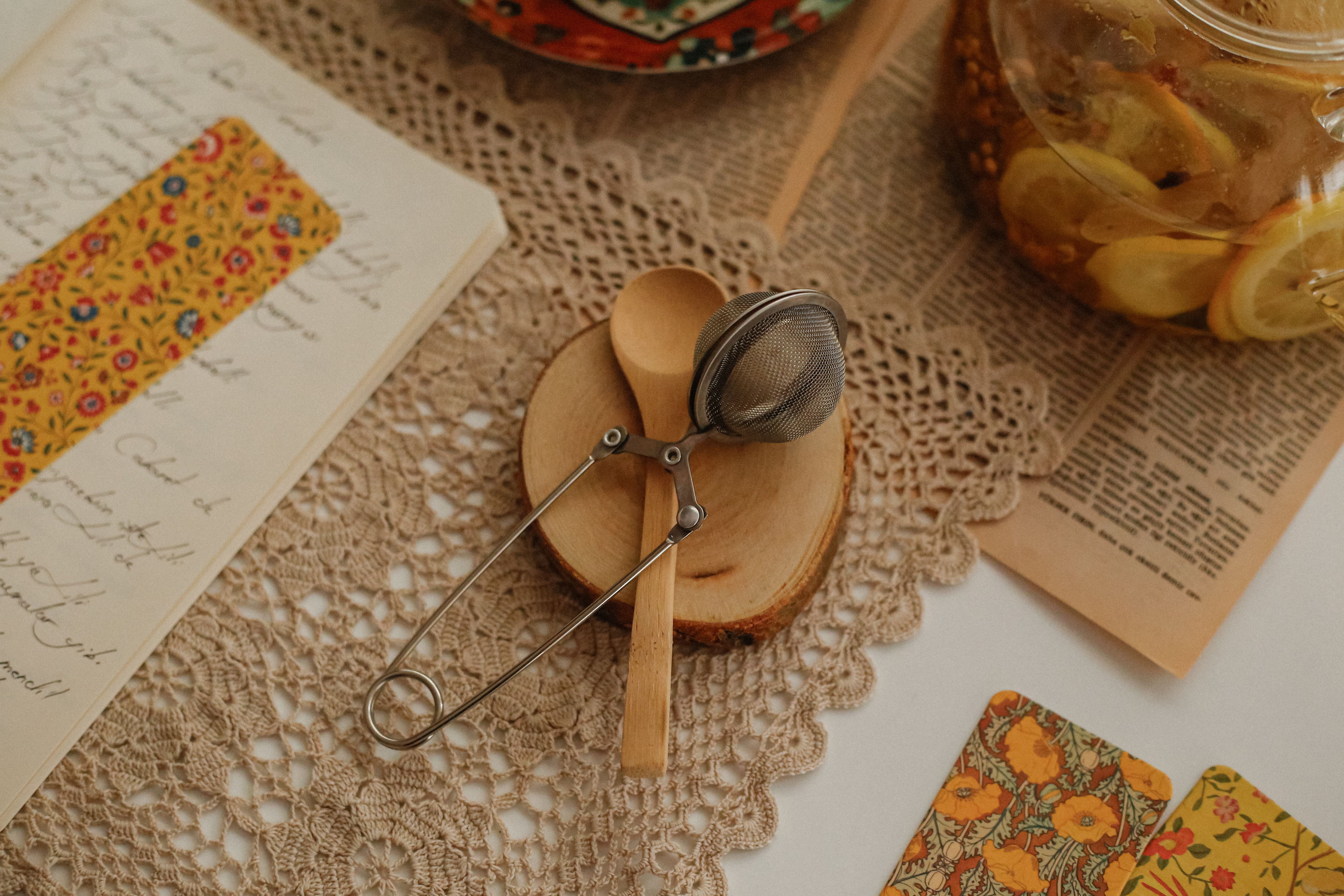 a handwritten recipe card with splattered sauce stains, sitting on a kitchen counter next to a cup of tea