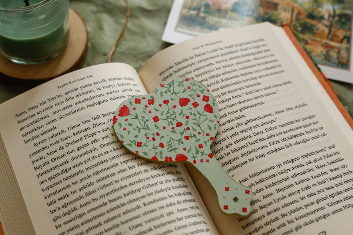 A floral bookmark resting in an open book