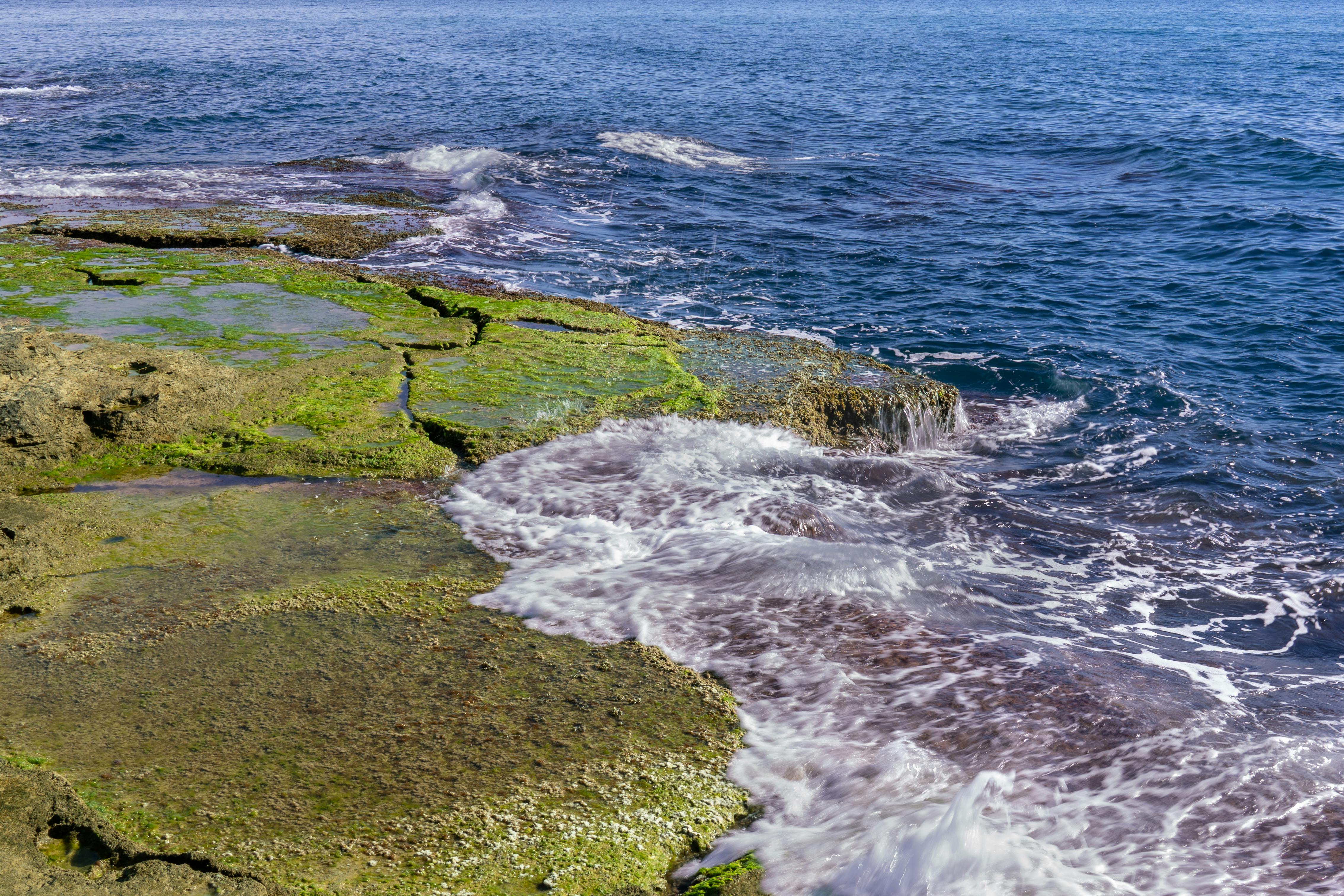 Breathtaking view of rocky coastline with waves crashing in Torrevieja, Spain.