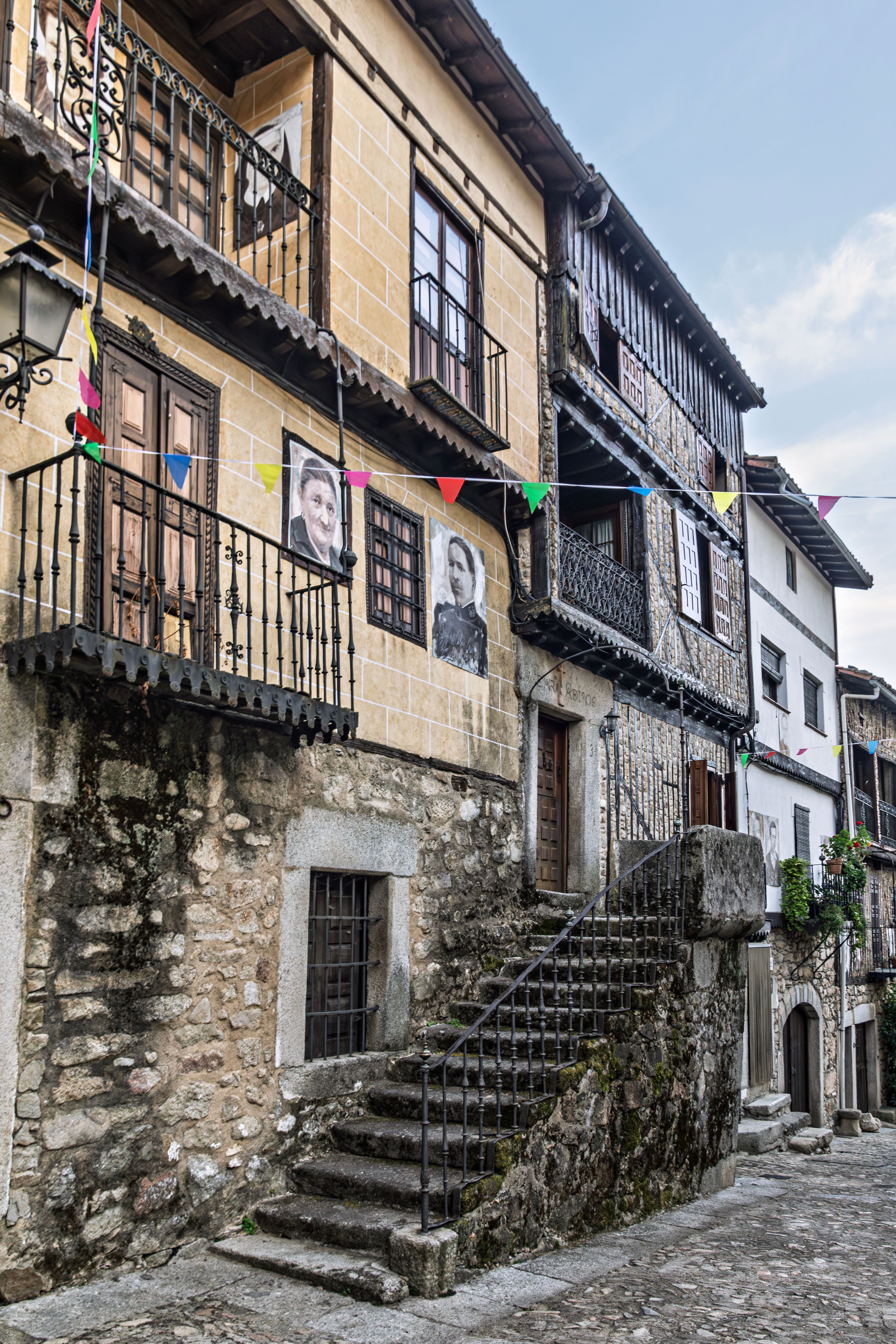 Charming Historic Stone Street with Festive Flags · Free Stock Photo