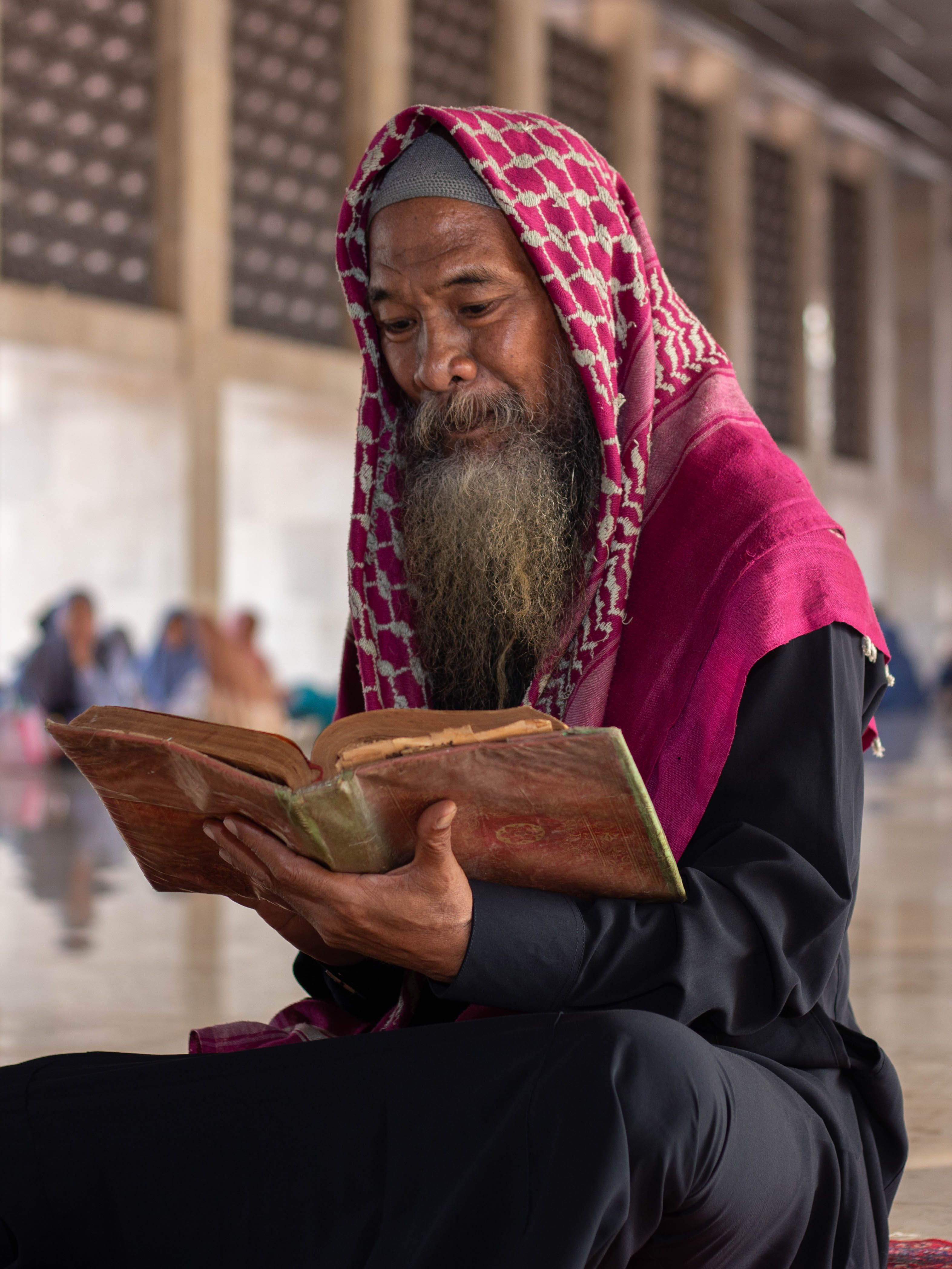Elderly Man Reading Religious Text in Mosque · Free Stock Photo