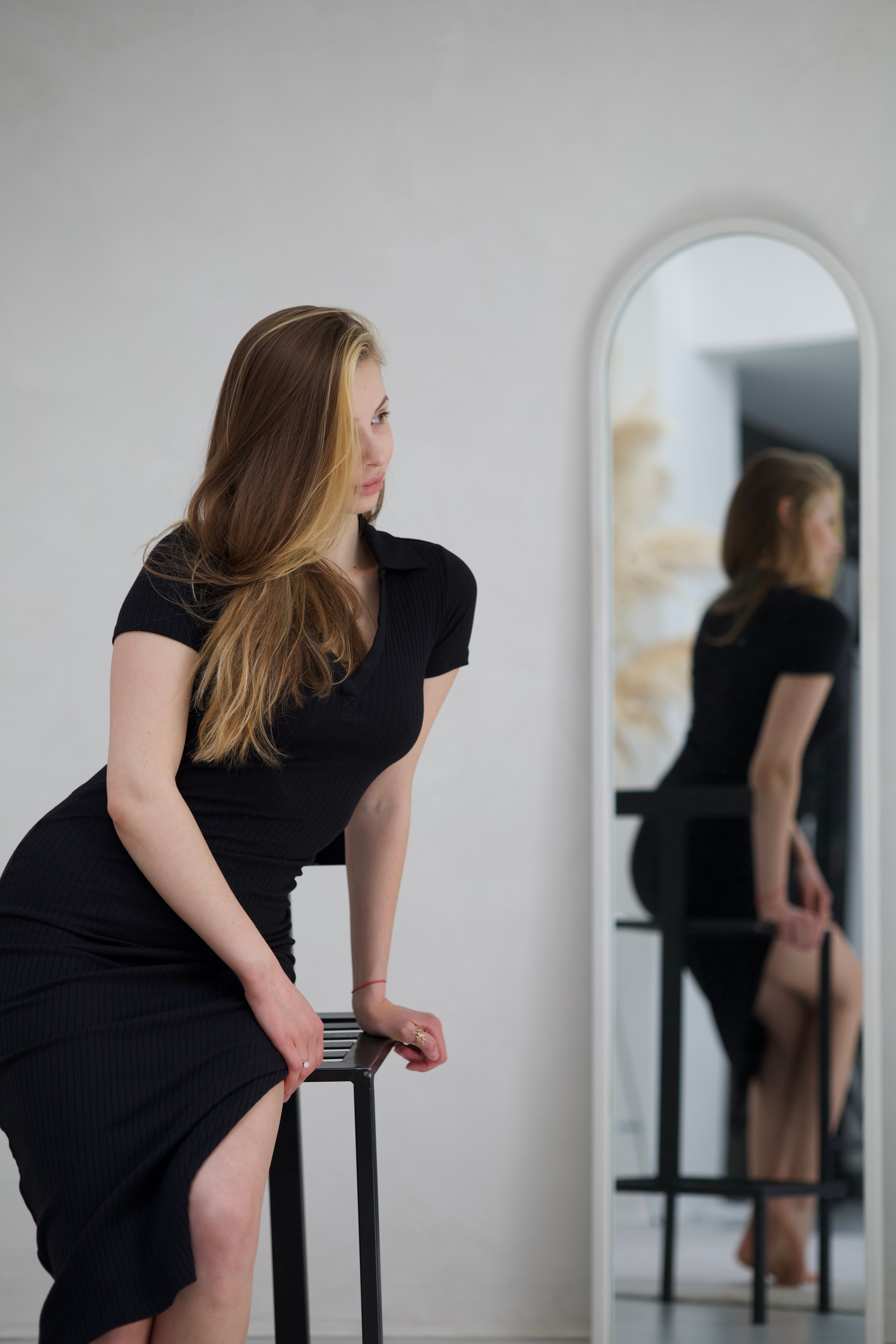 Elegant Woman in Black Dress Posing Indoors · Free Stock Photo