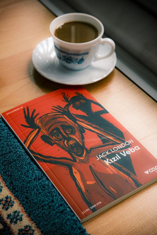 Free A book by Jack London next to a steaming cup of coffee, perfect for cozy reading. Stock Photo