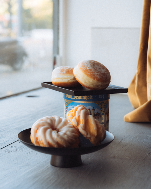 Free A selection of fresh pastries including Berliner donuts and spritzkuchen on a table. Stock Photo