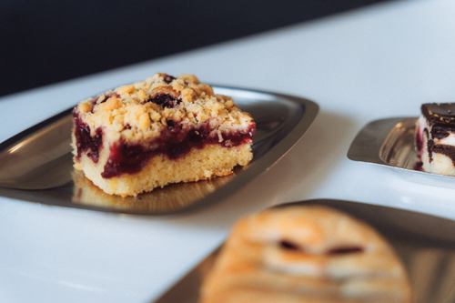 Free Close-up of a piece of streuselkuchen with berry filling on metal plate. Stock Photo