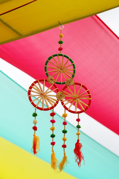 Free Vibrant hanging decoration with colorful beads and tassels set against a bright background. Stock Photo