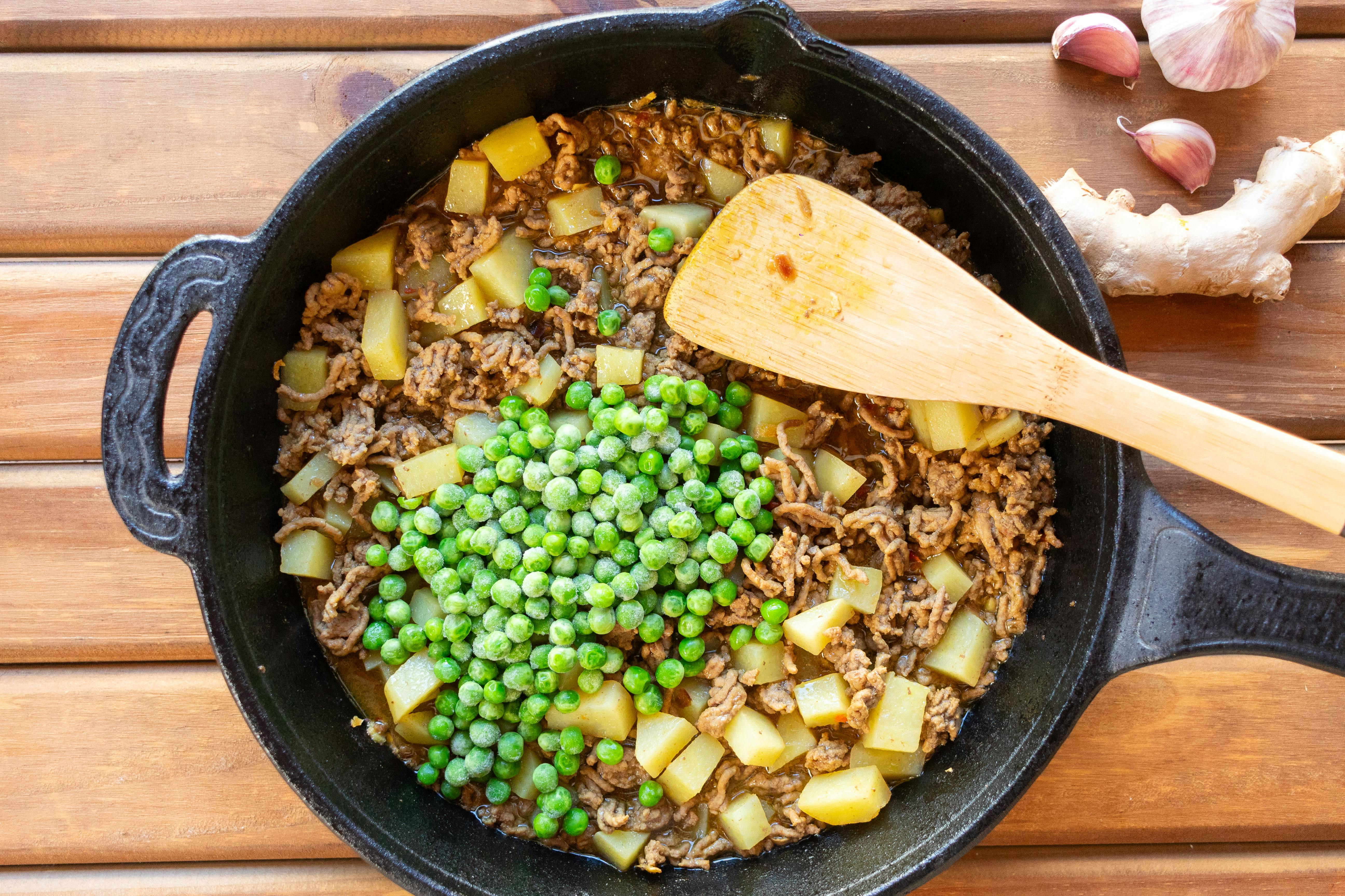 A hearty skillet dish featuring beef, peas, and potatoes, perfect for a comforting meal.