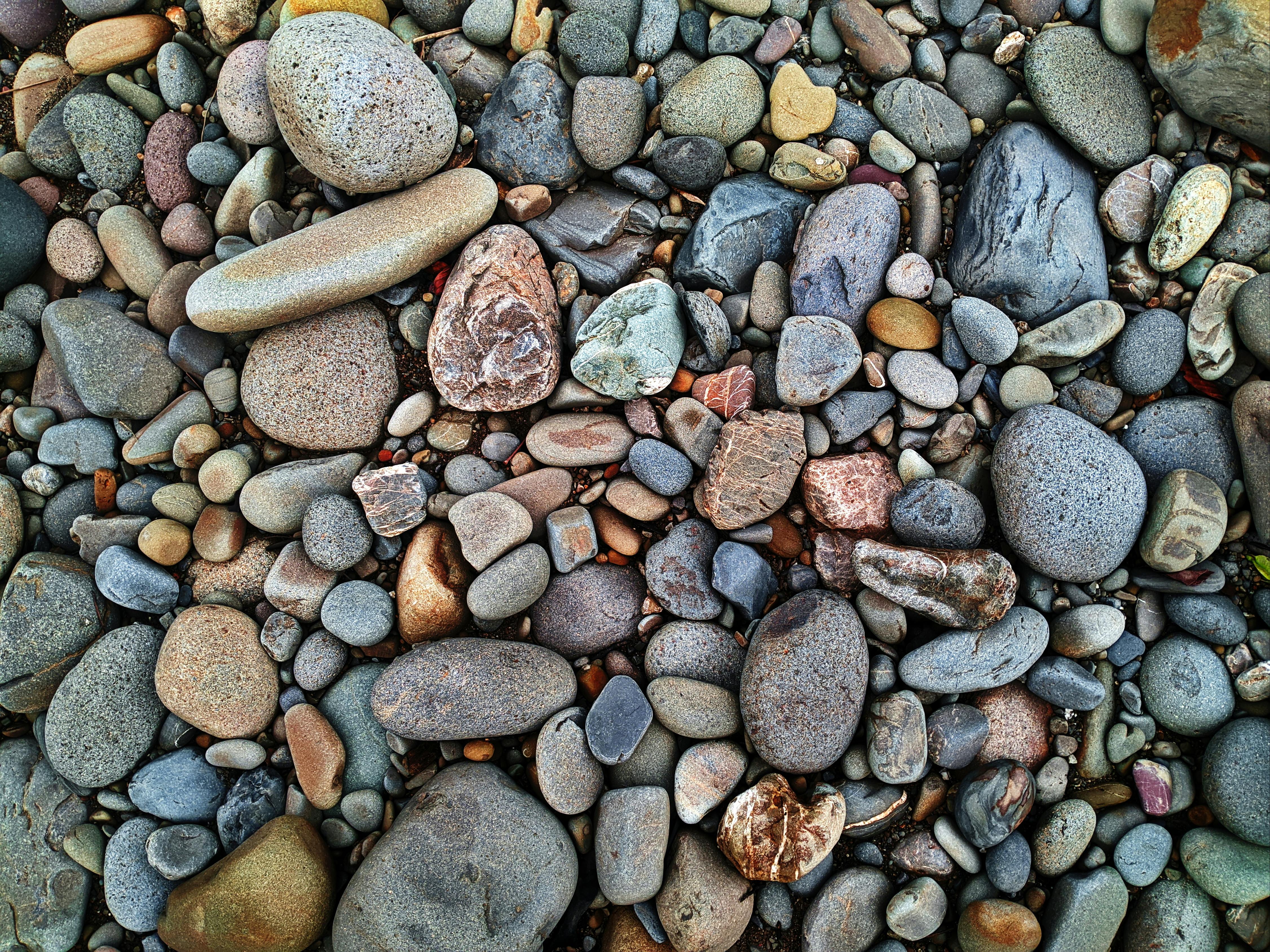 A detailed shot of colorful river stones in North Kalimantan, Indonesia, showcasing natural textures and hues.
