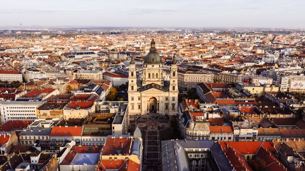 Explore a breathtaking aerial view of St. Stephen's Basilica in Budapest with its stunning architecture amid the city's landscape.
