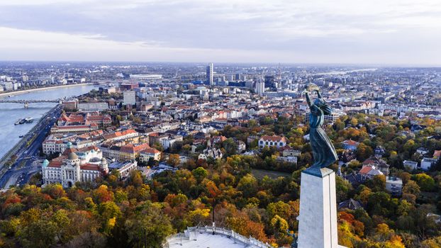 Stunning aerial view of Budapest with the iconic Liberty Statue overlooking the city and Danube River.