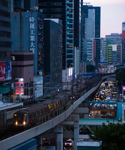 Free Downtown city view with train and traffic, captured at twilight. Stock Photo