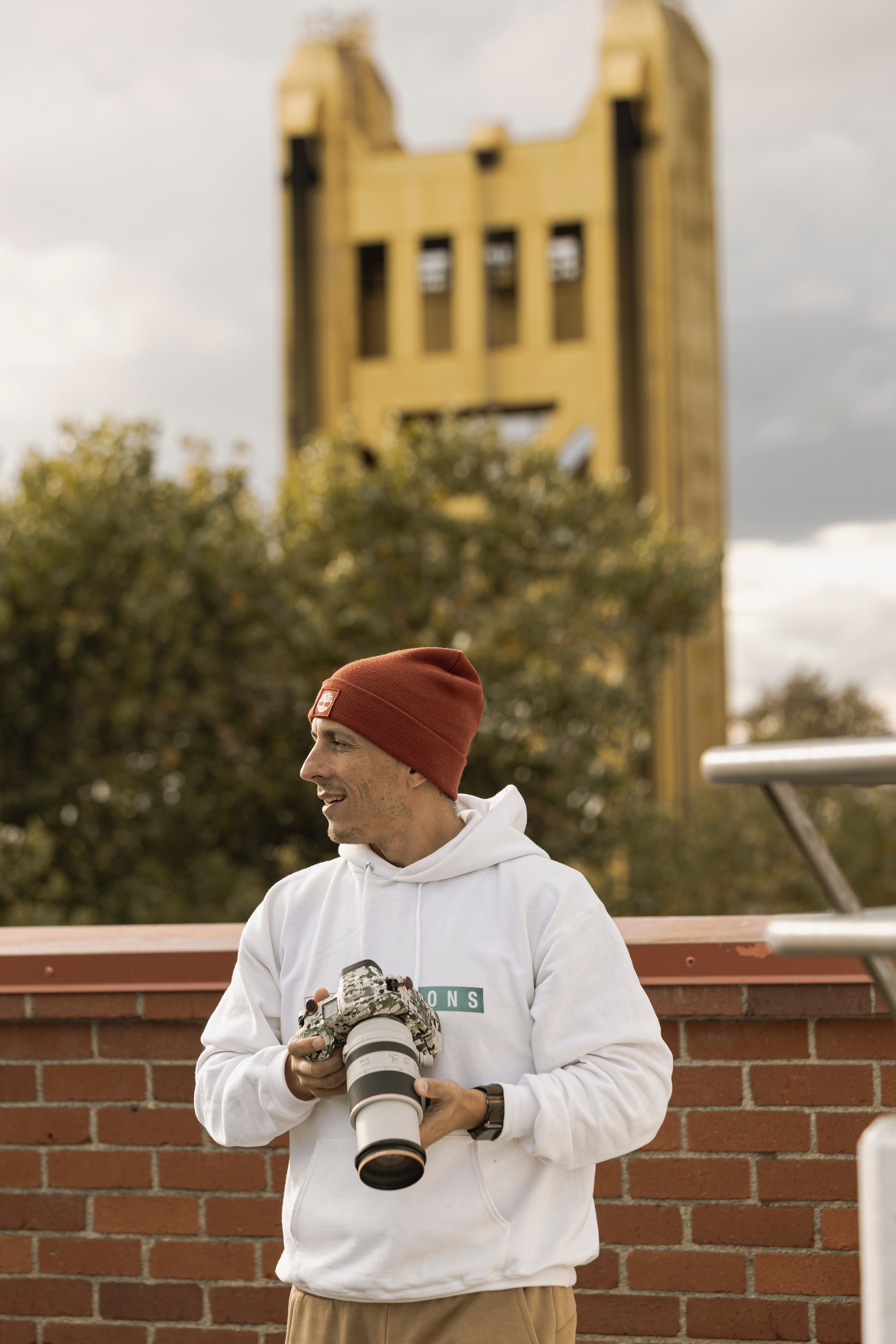 Casual male photographer with camera near Tower Bridge landmark outdoors