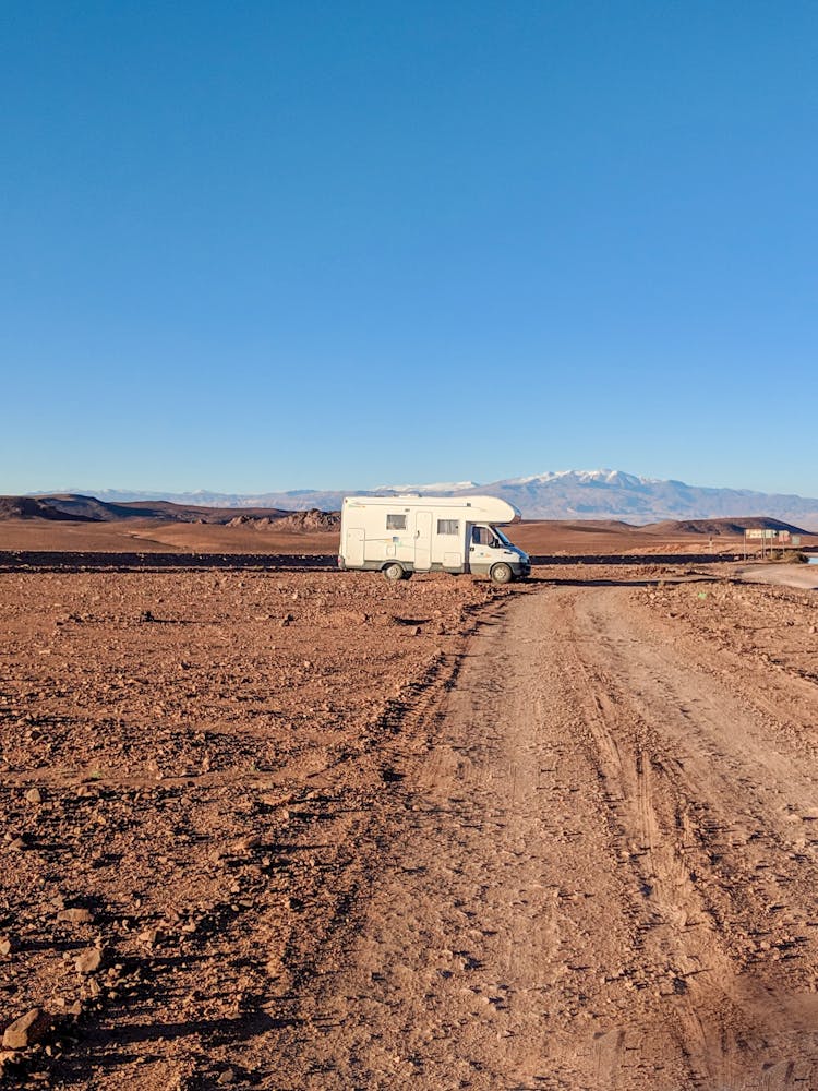 White Campervan On Dirt Road