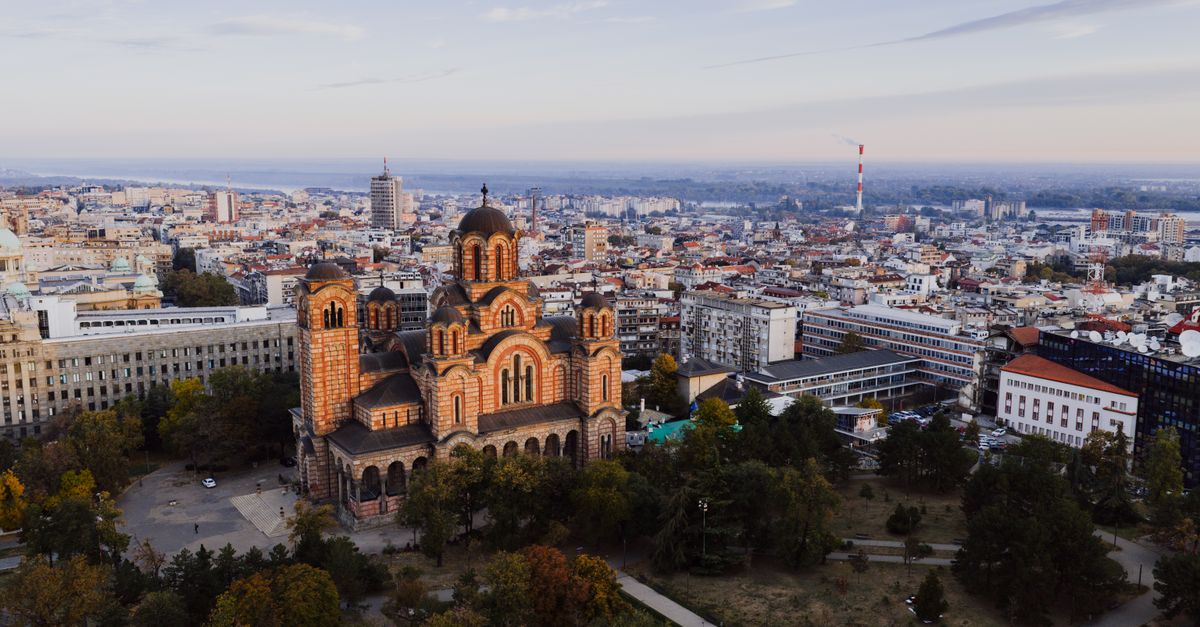 Aerial view of Ho city skyline at sunset with a modern church building in the foreground